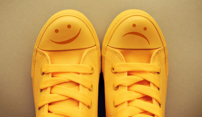Shoes wit a happy and sad face