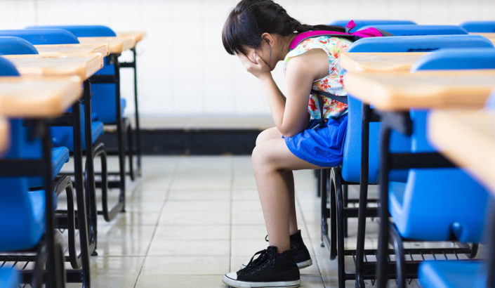 Student sitting alone in the classroom