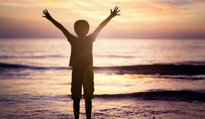 Child on the beach during sunset