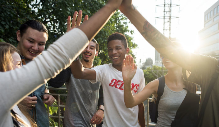 Friends giving high fives