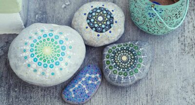 four stones painted with mandalas