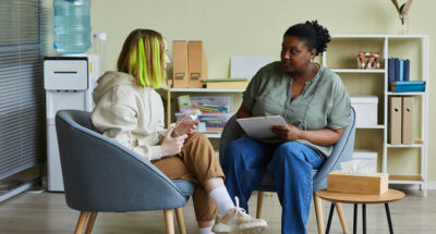 Teens talking and listening with compassion at school.