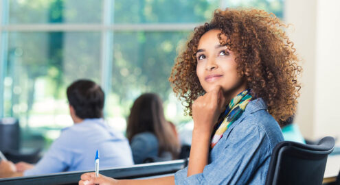 Black teenage girl sits in class and reflects on her identity.
