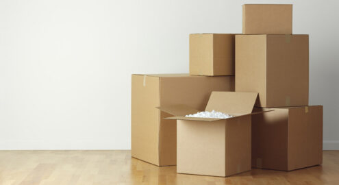 Stack of moving boxes on hardwood floor