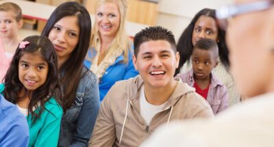 Parents and students attending school assembly or orientation