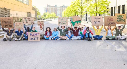 A group of young people protest by climate change and blocking the road