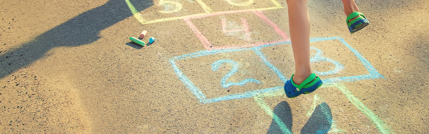 Image of child jumping and playing hopscotch
