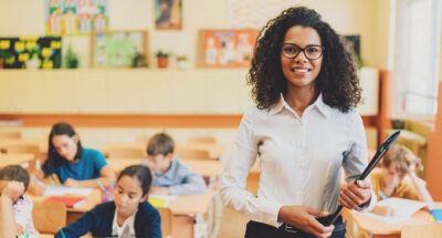 Portrait of mixed race teacher in class looking at camera