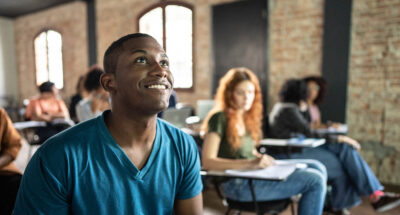 Black high school student looks up at lesson with enthusiasm and purpose