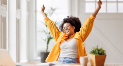 Jubilant woman at desk