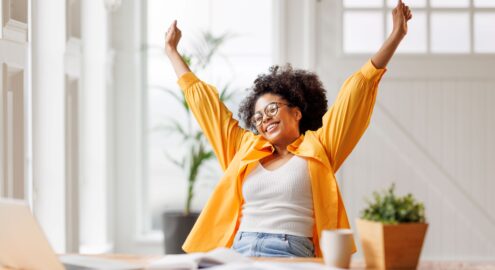 Jubilant woman at desk