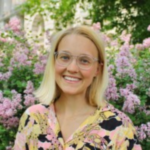 Happy woman with glasses smiling at camera