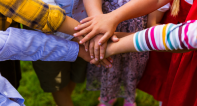 Kids putting their hands together