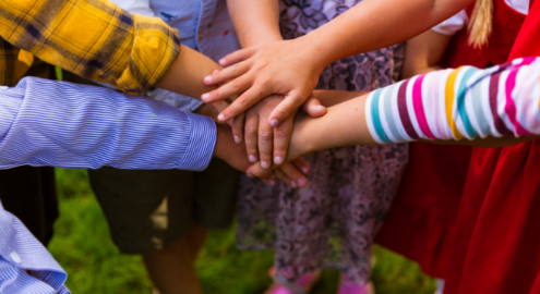Kids putting their hands together