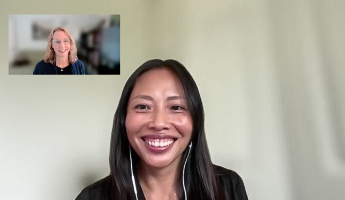 Image of happy smiling person on zoom screen with small square of smiling person in corner on another screen