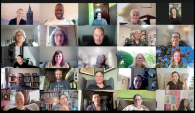 Zoom meeting with lots of diverse people in gallery view, looking happy and at one another