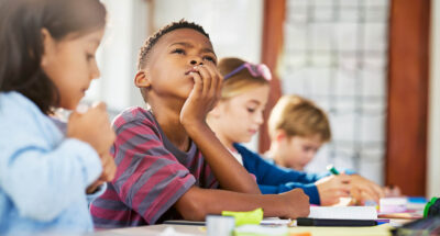 Young black student imagines what he might need to achieve his goals.