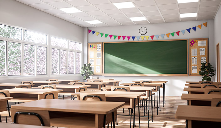 empty classroom with simple desks and a chalkboard at the front